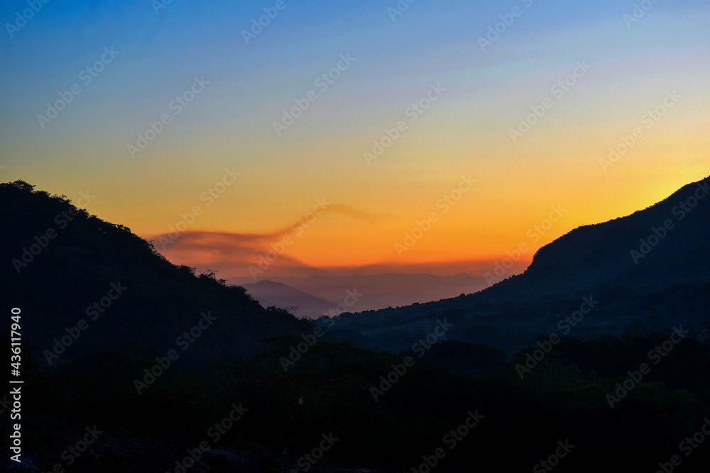 A sunset between the mountains of the south coast region