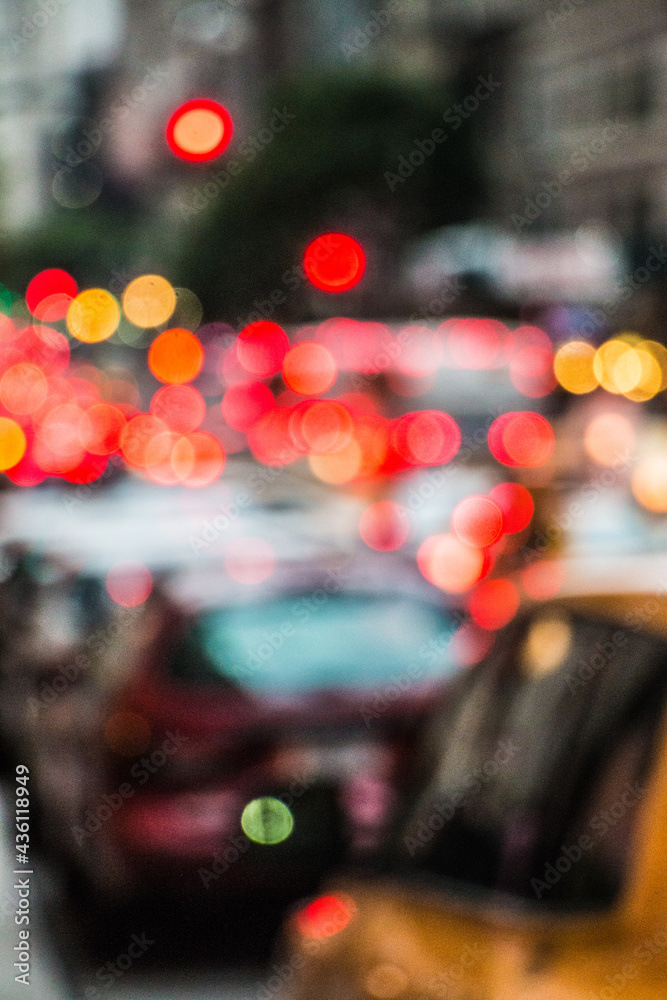 Traffic in New York City. Cars and taxis out of focus. Bokeh effect in the lights. Vertical