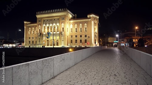 Historical Seher Cehaja Bridge and National and University Library of Bosnia and Herzegovina (former City Hall) at nigth with city traffic photo