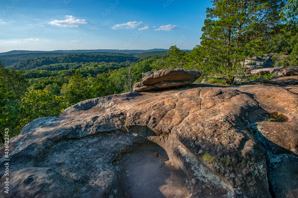 Forested mountains fading to the horizon seen from the top of a weatered, rocky outcrop. Garden of the Gods, Illinois 