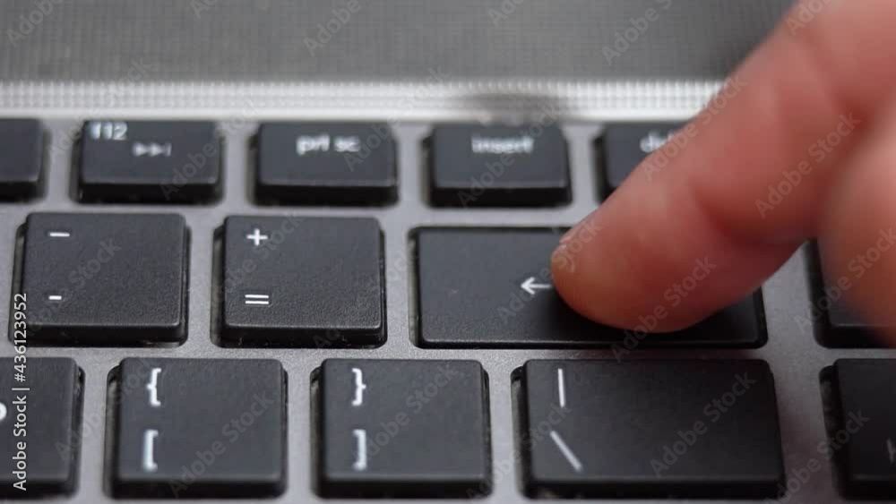 Backspace button pressing on keyboard, laptop keyboard close up