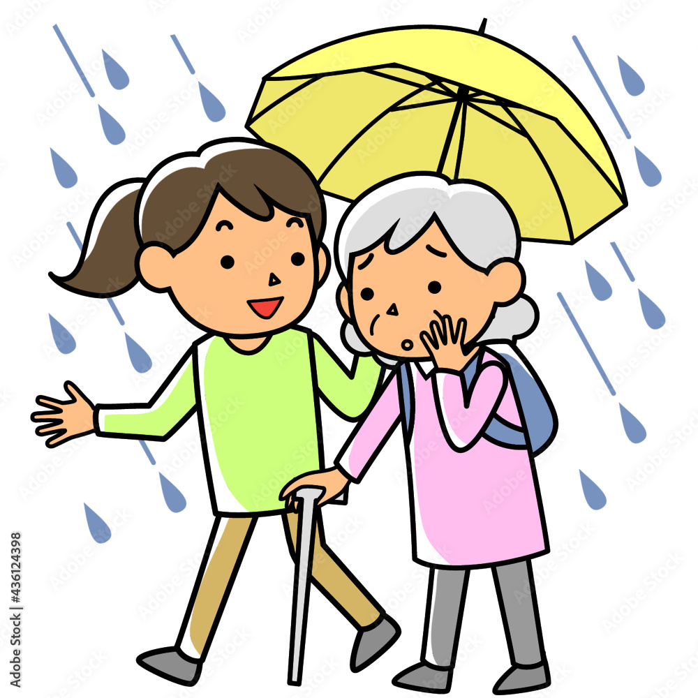 雨の中避難する高齢者を支援する女性 雨の中避難する高齢者を支援する女性