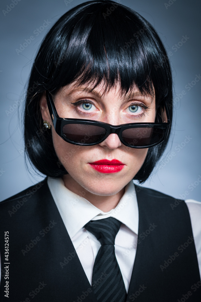 Cheeky Young Citizen with Black Hair, Dark Suit, Red Lips and Mysterious Shades. Cheeky Young Citizen with Black Hair, Dark Suit, Red Lips and Mysterious Shades.