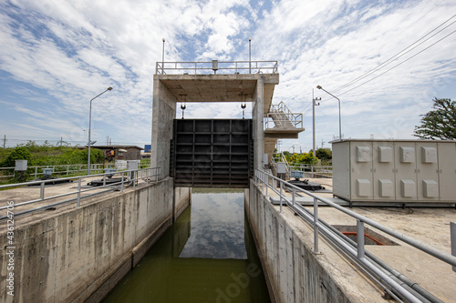 Watergate for balancing water level in the canal. Concept of water management, agriculture, watergate, saving the environment.