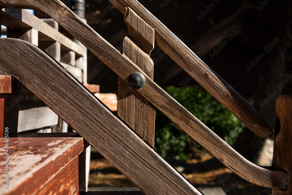 Wooden handrail of a Japanese temple with an iron nail in detail. Wooden handrail of a Japanese temple with an iron nail in detail.