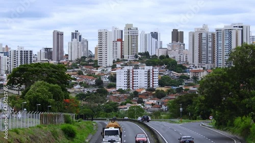 Time lapse of vehicles traffic on the SP-294 - Highway Commander Joao Ribeiro Barros with building of downtown in the background photo