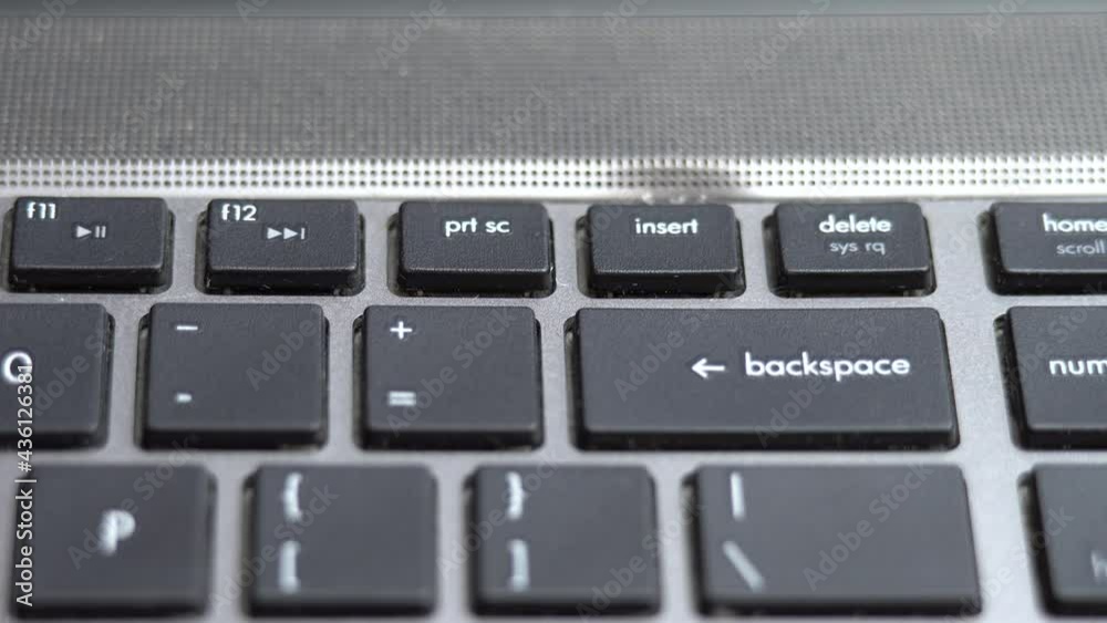 Backspace button pressing a lot of times on keyboard, laptop keyboard close up