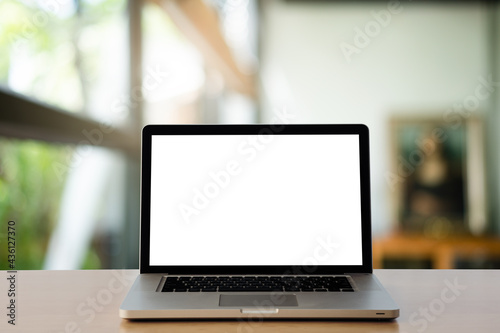 Front view of the laptop on the work desk in the office blur background. 