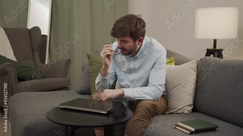 A european man ends conversation in video call and rests. photo