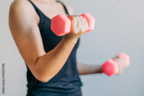 young women lifting dumbbell exercise at home, female doing workout sports indoors, healthy lifestyle concept.