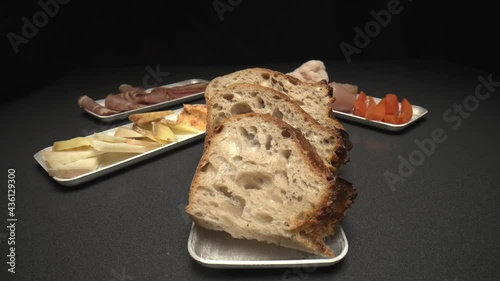 Close up shot of chef plating bread with apetizers photo