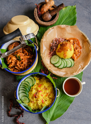 Homemade traditional Peranakan Malaysian cuisine / Nasi Kunyit aka Turmeric Glutinous Rice / Delicious dish eaten with dry curry chicken with glutinous rice cooked in coconut milk and turmeric