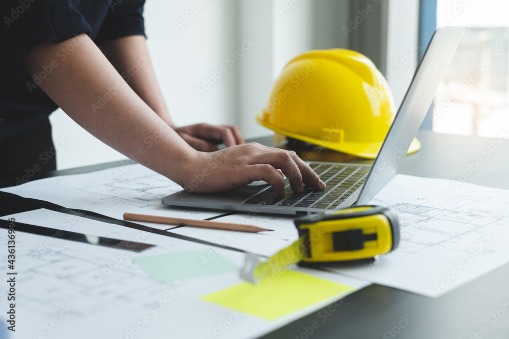 Architects or engineers working construction and drawing construction plans, printing, writing on-site construction sites. Home design concept Architects or engineers working construction and drawing construction plans, printing, writing on-site construction sites. Home design concept