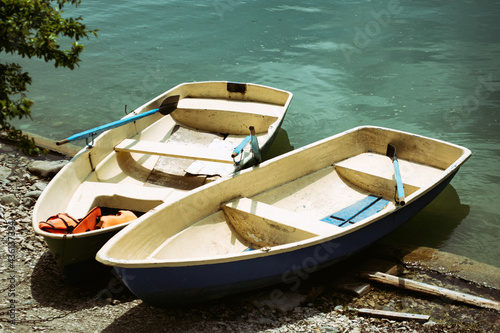 Two small boats on the lake. © vladorlov