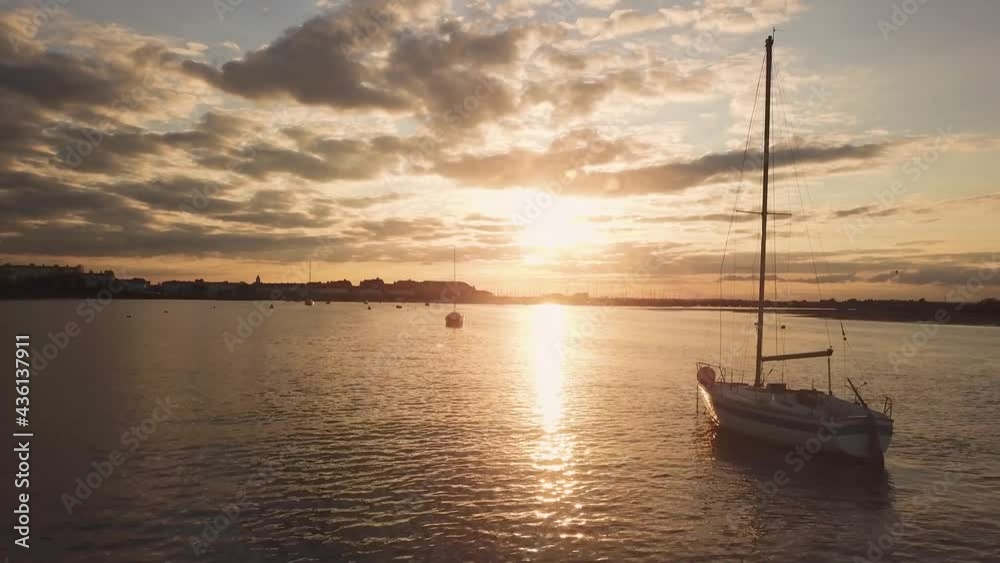 Aerial view of a sunset with a yacht docked in Malahide Marina, Ireland Aerial view of a sunset with a yacht docked in Malahide Marina, Ireland