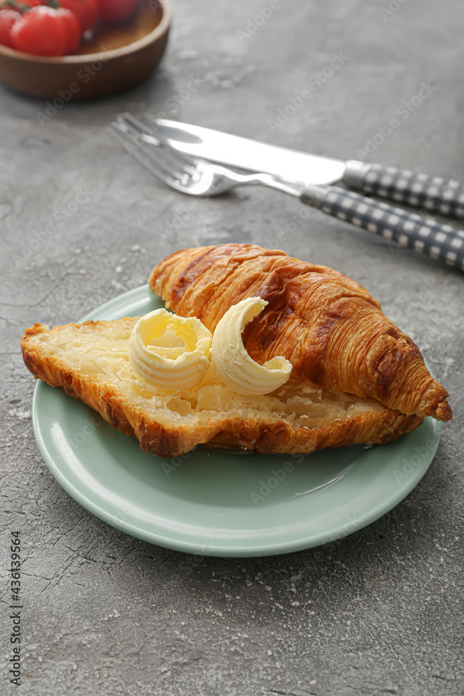 Tasty croissant with butter on grunge background Tasty croissant with butter on grunge background