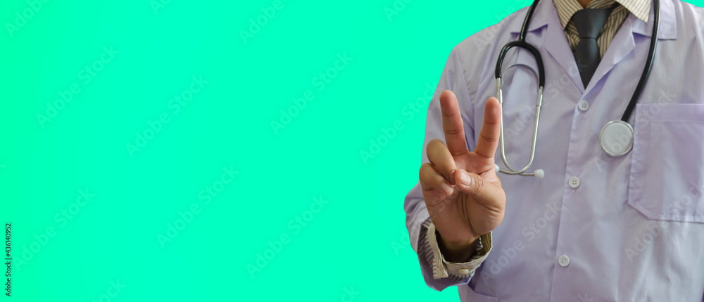 doctor held a two-finger symbol on green background. Encourage the patient and the doctor to treat severe disease together.