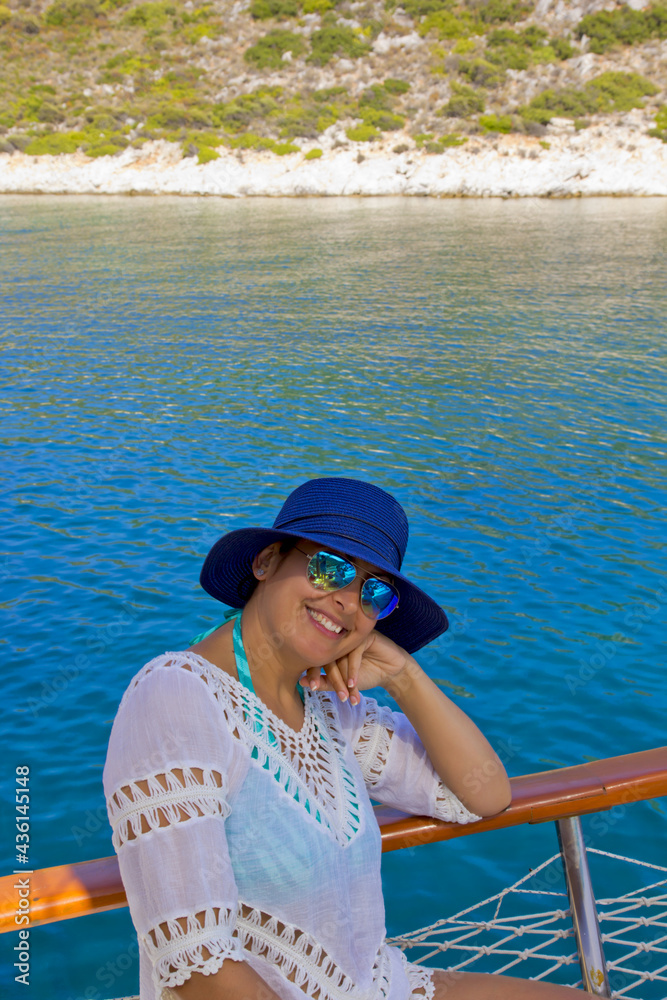 happy woman in a blue hat smiling at camera