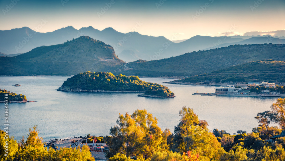Calm spring view of Ksamil town. Aerial morning seascape if Ionian sea. Stunning outdoor scene of Butrint National Park, Albania, Europe. Traveling concept background..