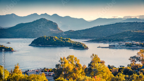 Calm spring view of Ksamil town. Aerial morning seascape if Ionian sea. Stunning outdoor scene of Butrint National Park, Albania, Europe. Traveling concept background..