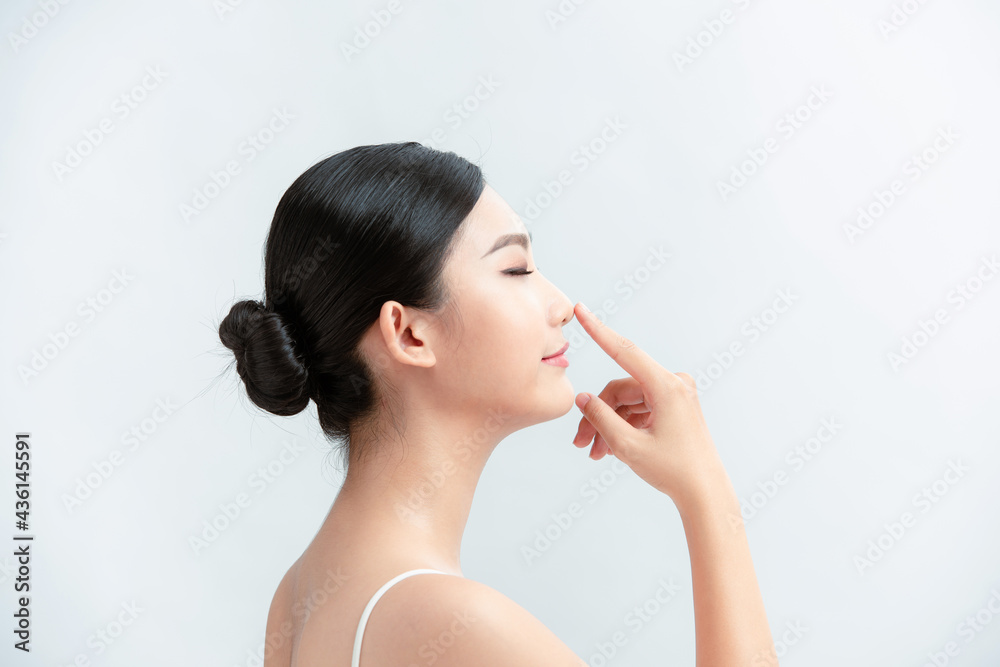 Side profile of asian lady pointing her nose Side profile of asian lady pointing her nose