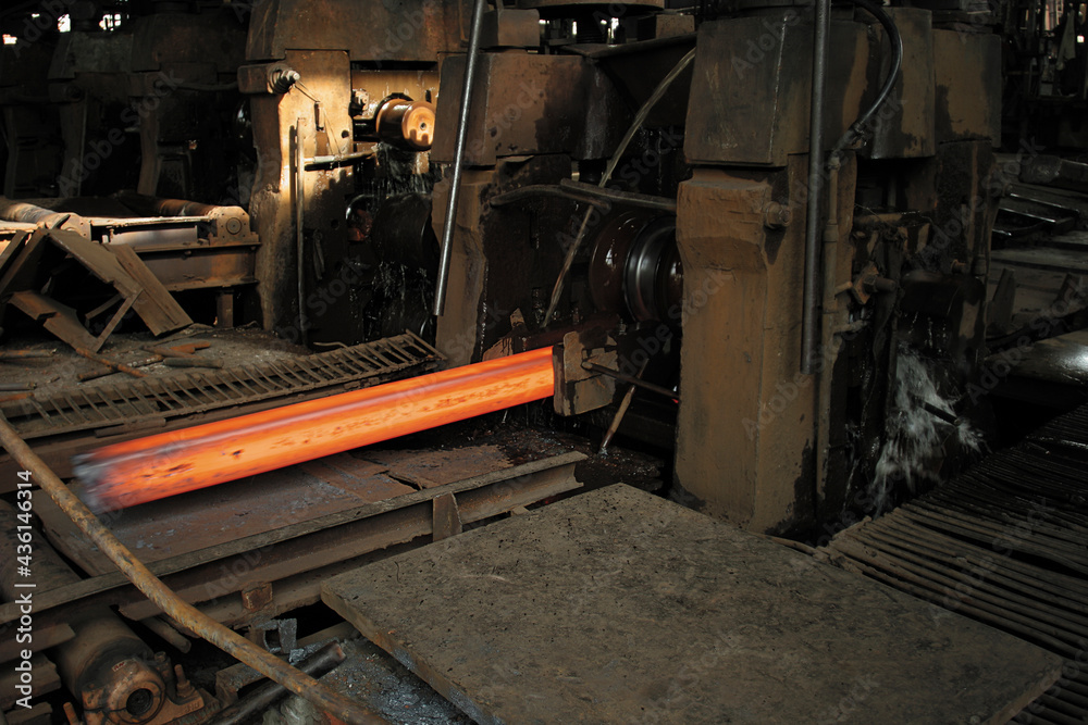 red hot steel bars are being rolled to different sizes in a rolling mill
