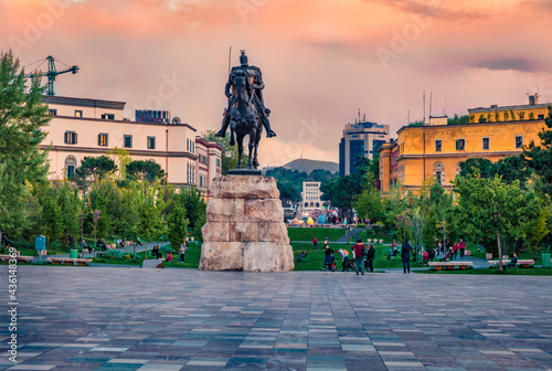 Monument of Skanderbeg in Scanderbeg Square. Colrful spring sunset in the capital of Albania - Tirana.