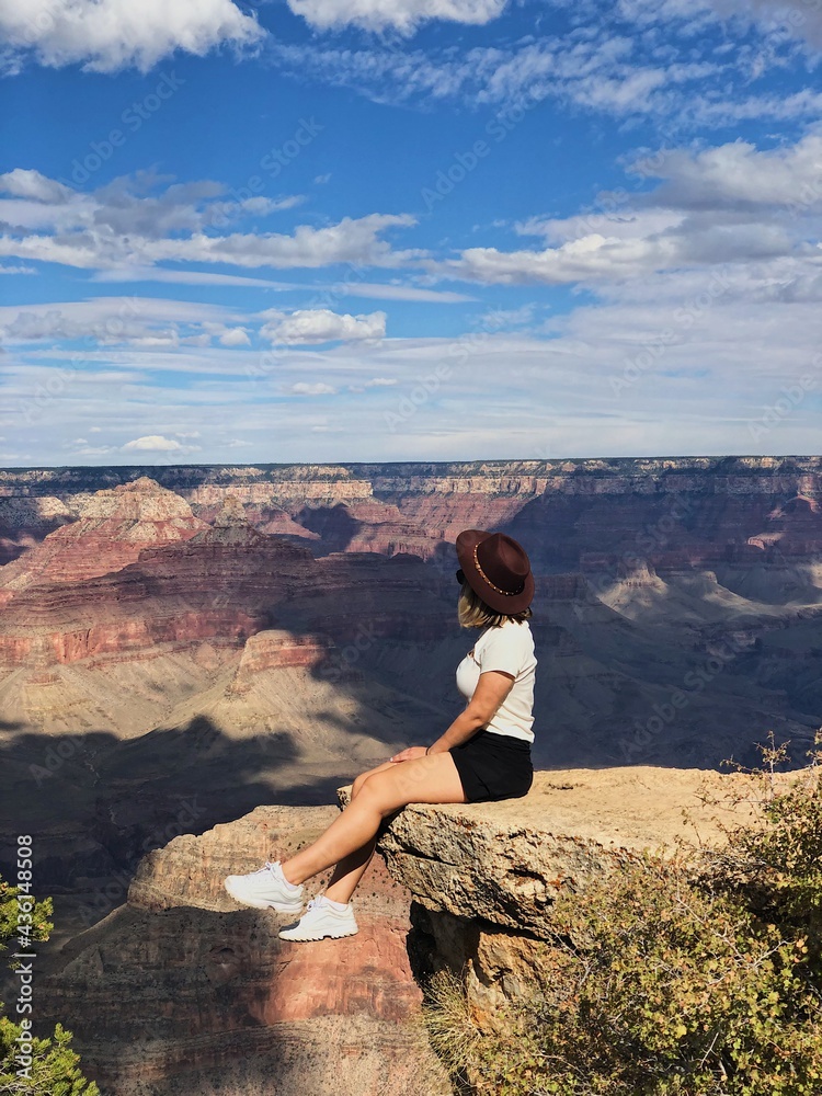woman sitting on the rock grand canyon romantic landscape, dreaming on the top of the rock woman on the cliff
