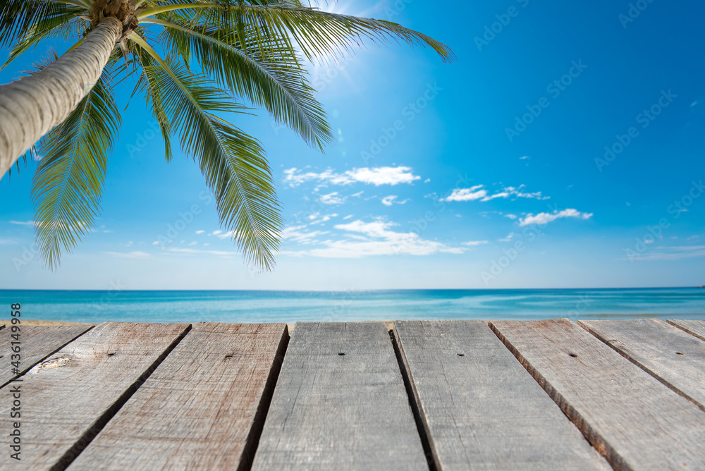 Wooden floor or plank on blurred background of the sea in summer. For product display.