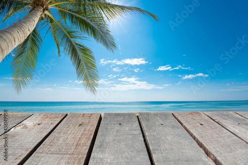 Wooden floor or plank on blurred background of the sea in summer. For product display.