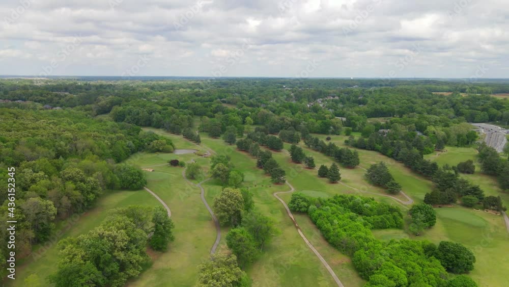 Flying over a beautiful green golf course with storm clouds rolling in Flying over a beautiful green golf course with storm clouds rolling in