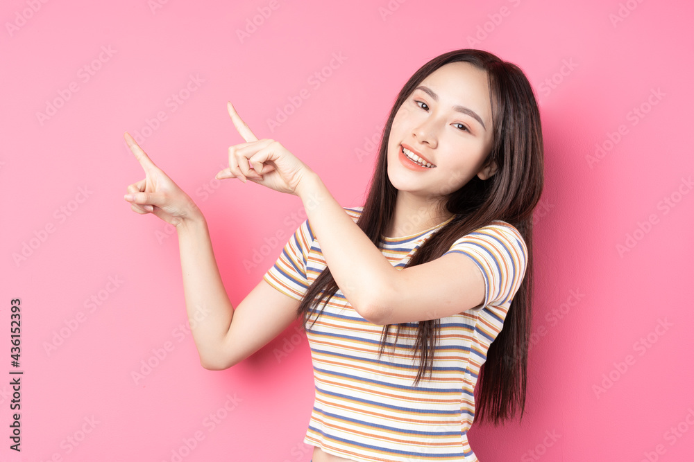 Young Asian woman posing on pink background Young Asian woman posing on pink background