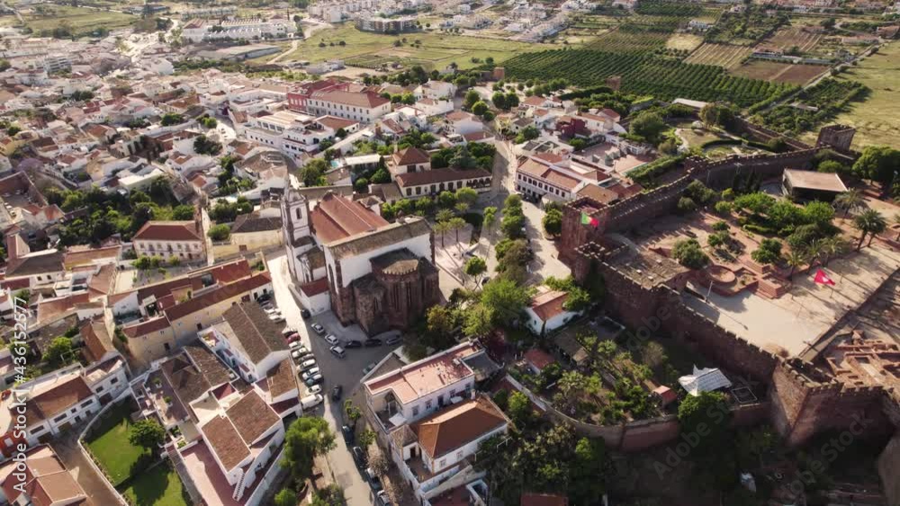 Aerial cityscape of the medieval town of Silves in Portugal, showing building and castle walls, bright daylight. Aerial cityscape of the medieval town of Silves in Portugal, showing building and castle walls, bright daylight.