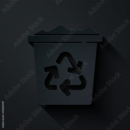 Paper cut Recycle bin with recycle symbol icon isolated on black background. Trash can icon. Garbage bin sign. Recycle basket sign. Paper art style. Vector