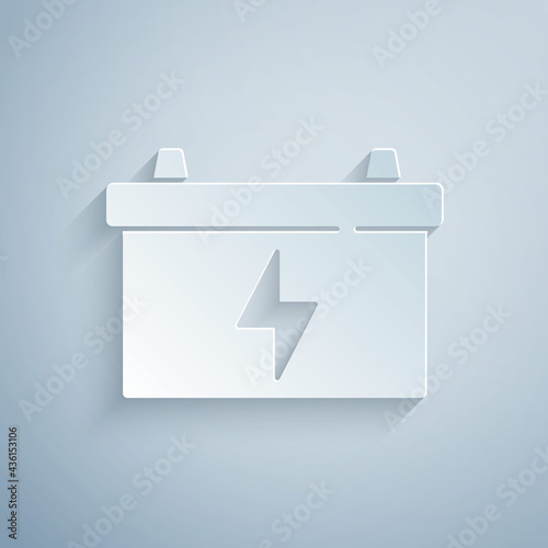 Paper cut Car battery icon isolated on grey background. Accumulator battery energy power and electricity accumulator battery. Paper art style. Vector