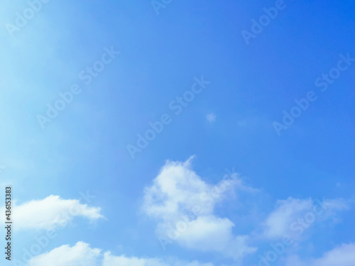 Blue sky with fluffy white clouds.  Beautiful sky in the morning.  Copy space is in the middle of photo.  The concept of new life beginning, freedom of life, positive energy and peaceful mind. 