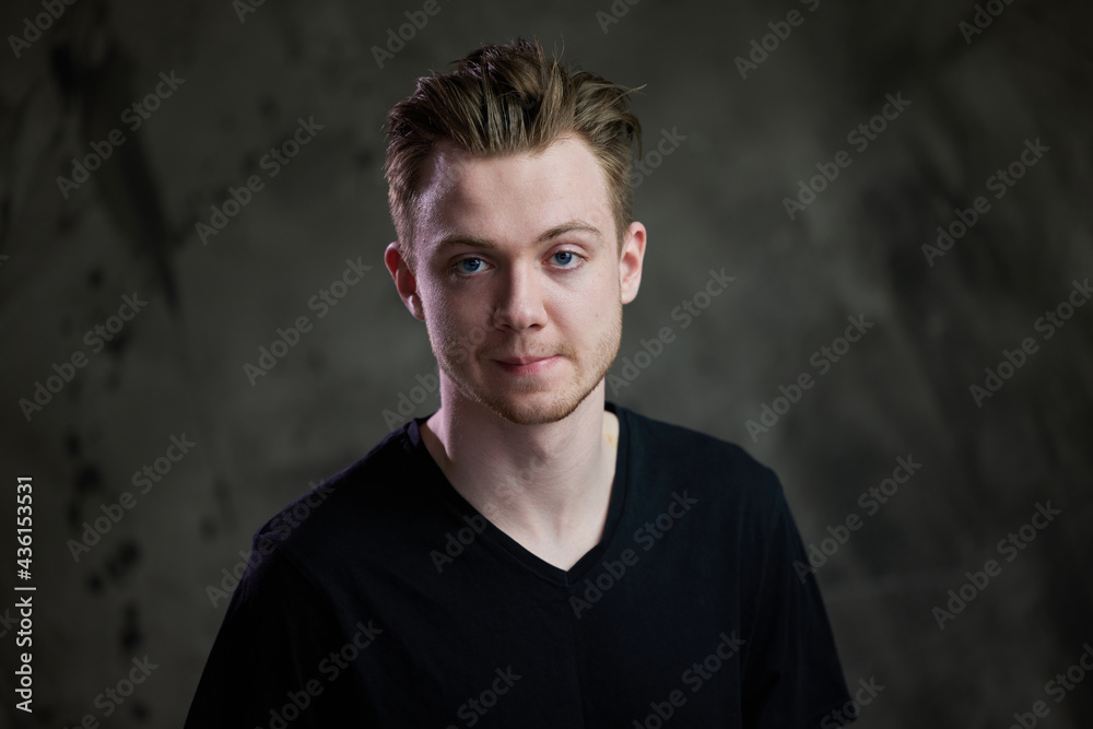 Portrait of a young caucasian man on a gray background