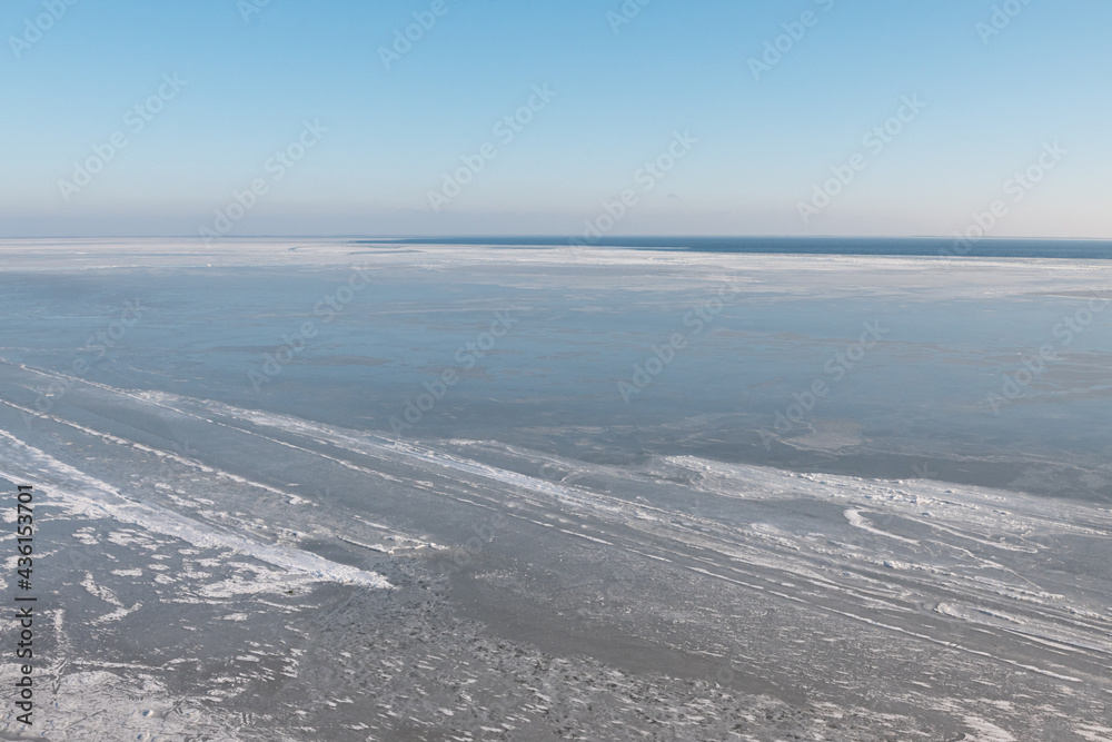 Aerial view of frozen Dnieper estuary covered with ice. Stanislav, Ukraine.