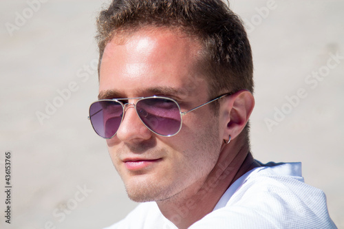 smiling young man relaxed and enjoying on the beach © tetxu