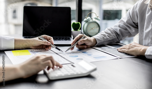 Two businessmen pointed to the material for the meeting, working together to plan to develop and solve common business problems. Concept of business management for growth and quality.