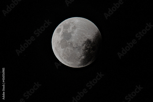 Super Flower Blood Moon lunar eclipse begins with the penumbral shadow appearing photo