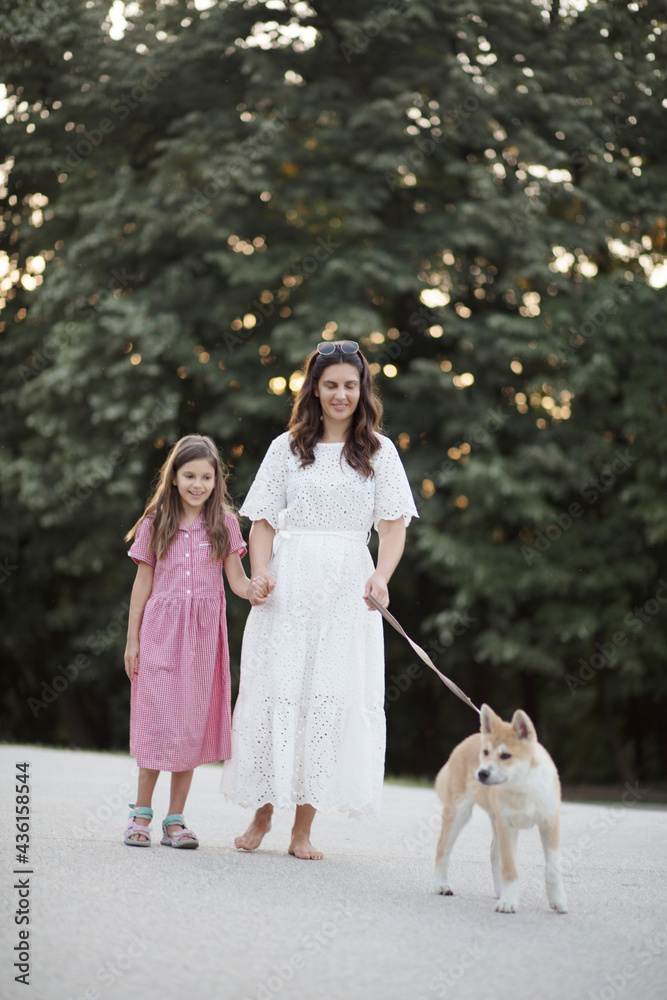 Mother and daughter walking with their dog in nature. Mother and daughter walking with their dog in nature.