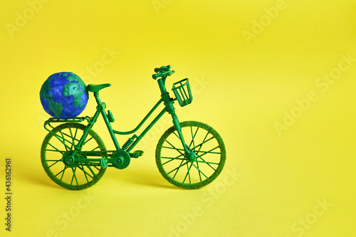 3rd June World Bicycle Day. Green bicycle on yellow background. Environment preserve.