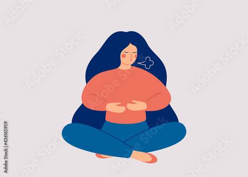 Woman makes Breathing exercise. Girl sits on the floor in pose lotus and makes a exhale. Recovery Respiratory system after illness. Health and wellbeing concept. photo