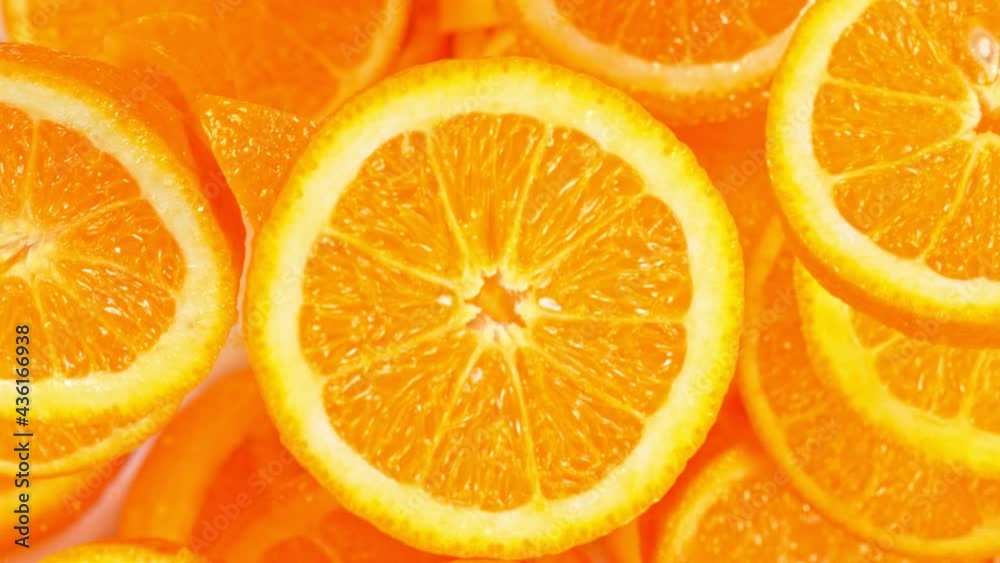 Super Slow Motion Shot of Flying Fresh Orange Slices Towards Camera at 1000 fps.