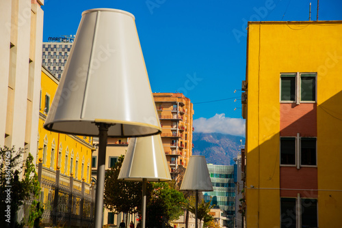 TIRANA, ALBANIA: Huge lanterns in the form of a lamp. Colorful apartment buildings in Tirana.