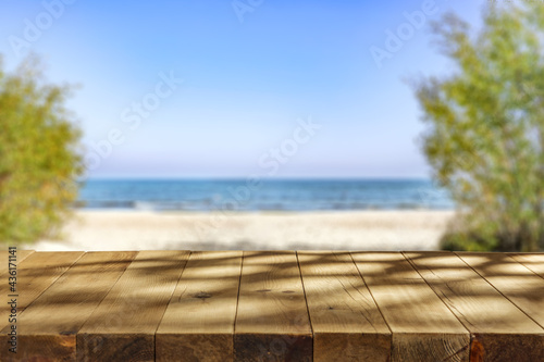 Fototapeta Naklejka Na Ścianę i Meble -  Wooden desk of free space and summer beach landscape 