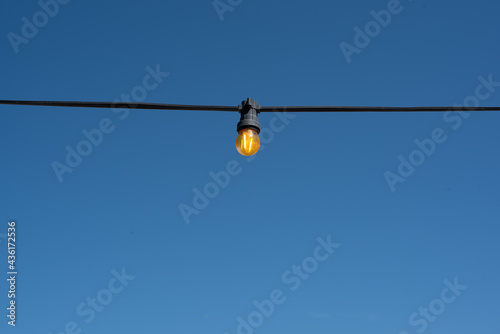 light bulb garland on the blue sky background