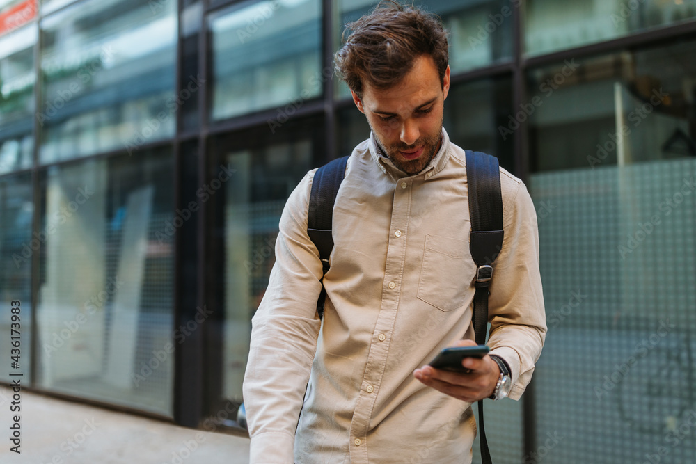 Man using phone while going to work with his bike next to him Man using phone while going to work with his bike next to him