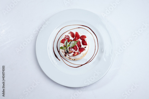 Strawberry pavlova cake on white plate